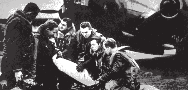 Josef Bernat's crew writing a message on a bomb in front of their Wellington