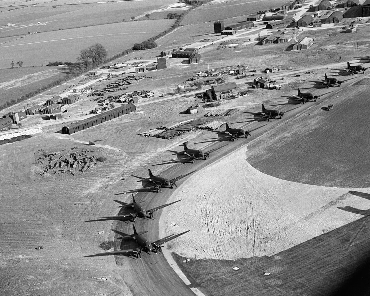 A line of RAF Dakotas on an airfield