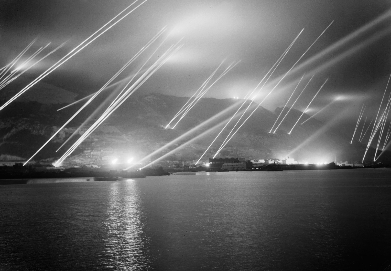 Anti-aircraft searchlight beams piercing the night sky