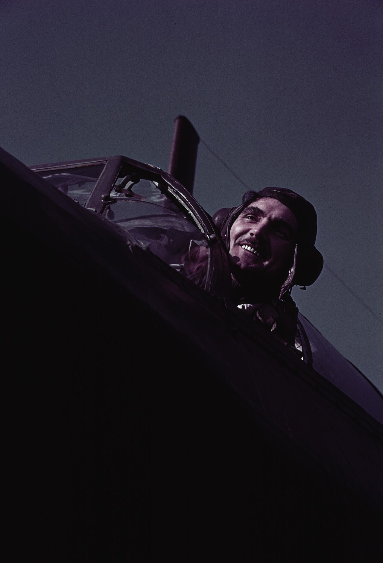 Colour photograph of a Wellington pilot in his cockpit, 1942